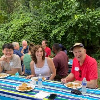 GVSU Alumni sit at picnic table at John Ball Zoo